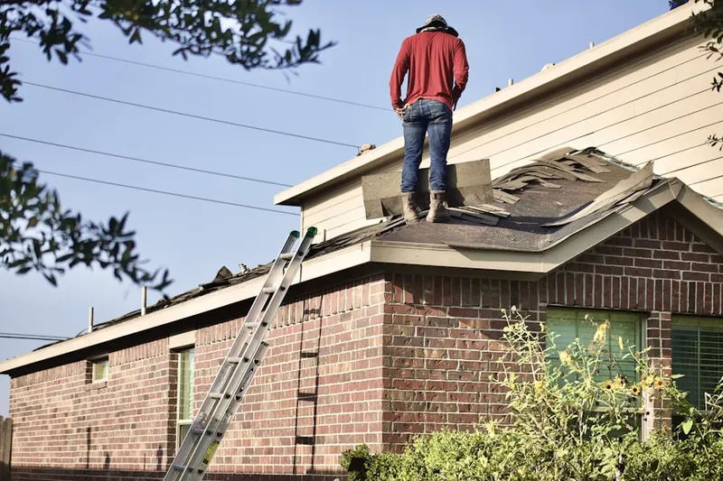 Professional roofer working on a residential roof in Pelzer